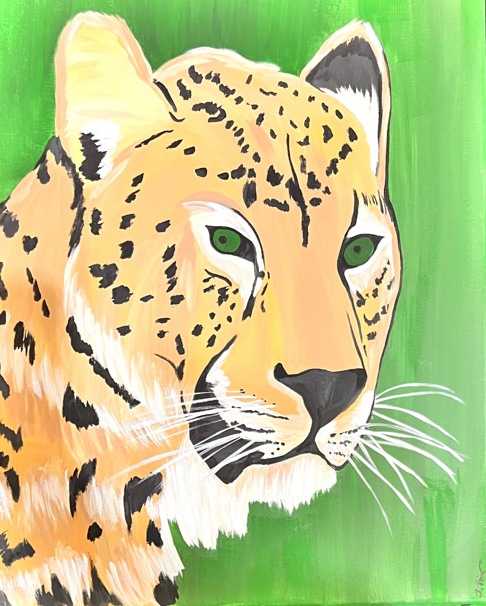 Close-up of a cheetah's face with green eyes, set against a green background.