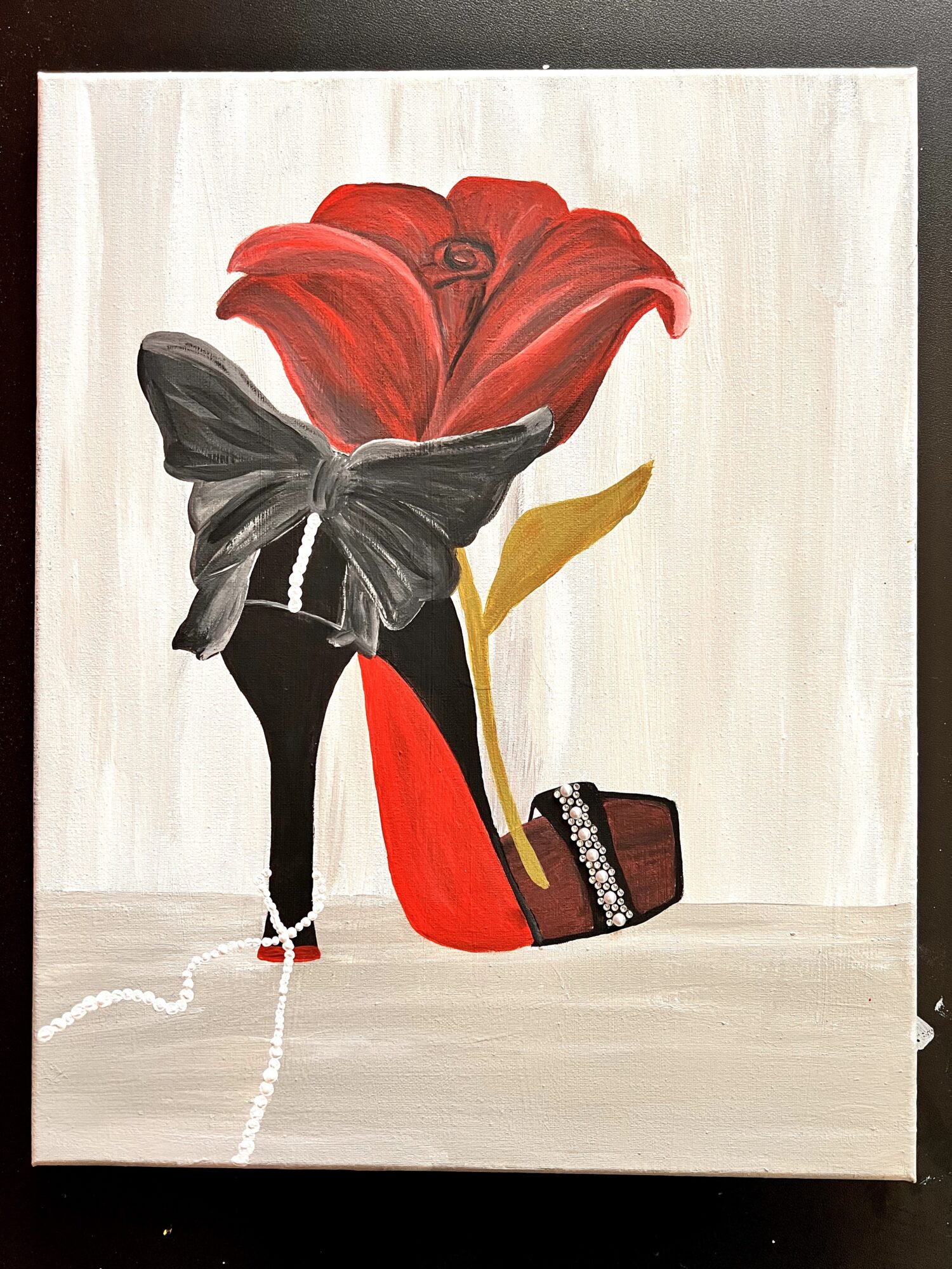 Person with black butterfly wings standing behind a large red flower, holding a brown handbag, with a white background.