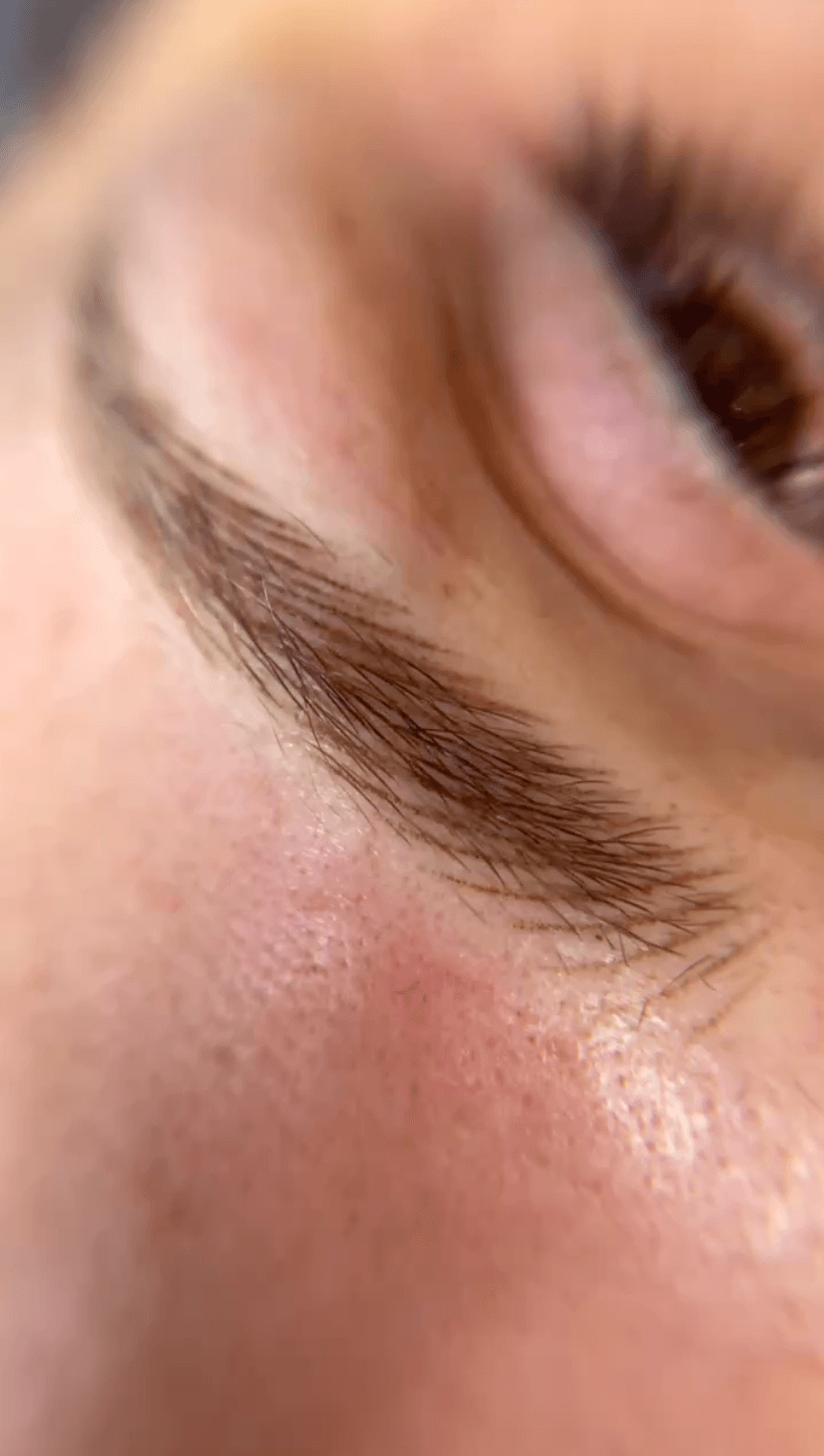 Close-up of a person's eye and eyebrow with skin visible, no rotation needed.