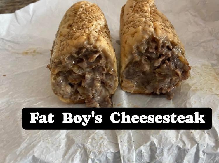 Two cheeseburgers with a crispy exterior and visible meat filling, labeled 'Fat Boy's Cheesesteak'.